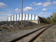 Portland Point Cement Works storage building; blue skies. cement and blue/white siding