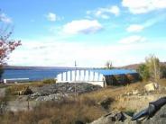 Portland Point Cement Works storage building; blue skies. cement and blue/white siding, lake in background