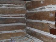Interior log cabin wall with makeshift bed