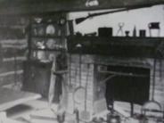 Black and white photo of interior of Log Cabin in the 1950's